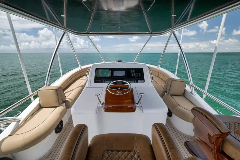 Slide: The Image of Luxurious 2018 Viking 92 Sky Bridge yacht interior with ocean view and elegant seating. - 58