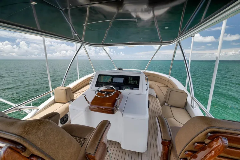 Slide: The Image of Luxurious 2018 Viking 92 Sky Bridge yacht interior with ocean view and elegant seating. - 59