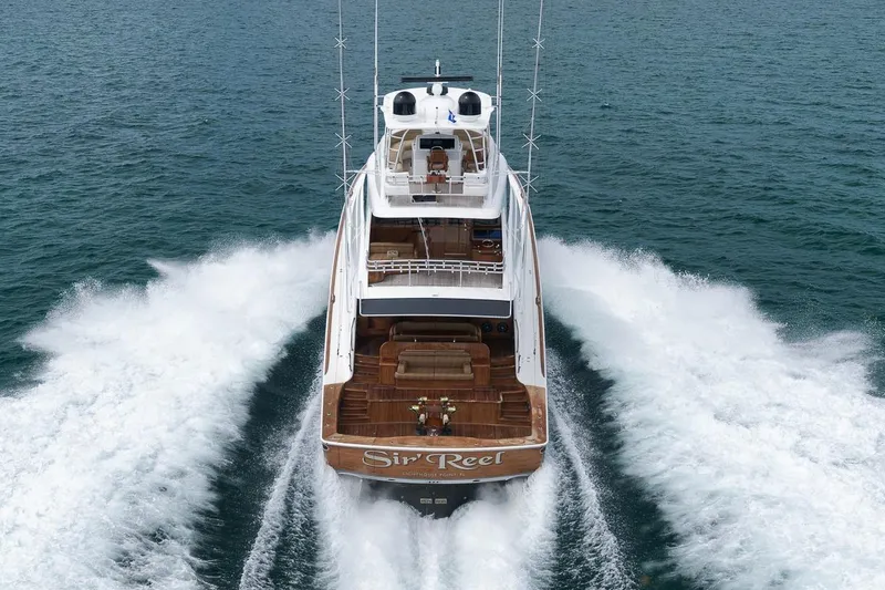 Slide: The Image of 2018 Viking 92 Sky Bridge yacht cruising on open water, rear view. - 6