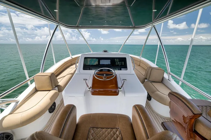 Slide: The Image of Luxurious 2018 Viking 92 Sky Bridge yacht interior with ocean view and elegant seating. - 60