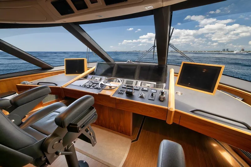 Slide: The Image of Luxurious helm of 2018 Viking 92 Sky Bridge yacht with ocean view. - 76