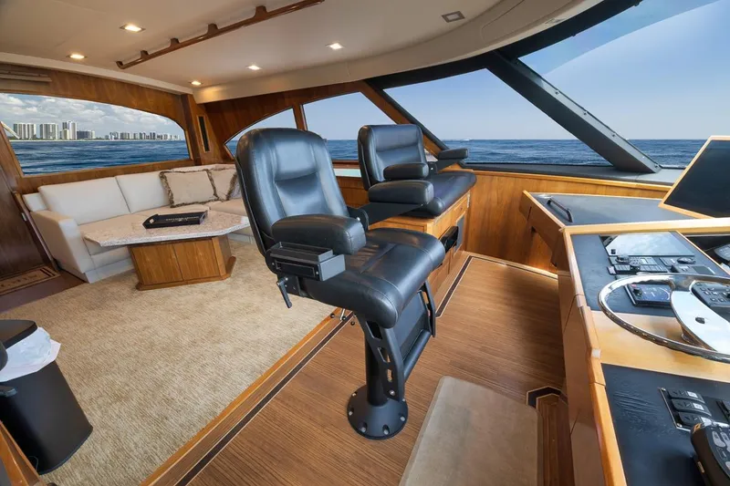 Slide: The Image of Luxurious interior of 2018 Viking 92 Sky Bridge yacht with ocean view and modern seating. - 79