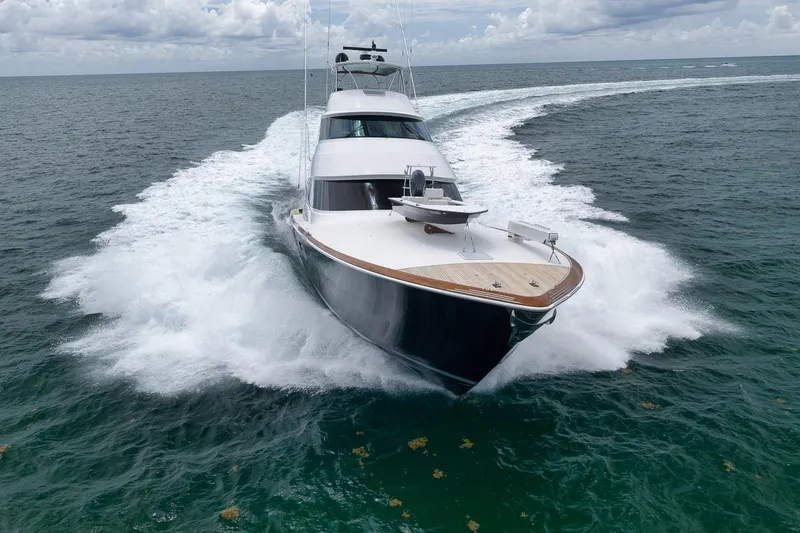 Slide: The Image of 2018 Viking 92 Sky Bridge yacht cruising swiftly on open ocean waters. - 8