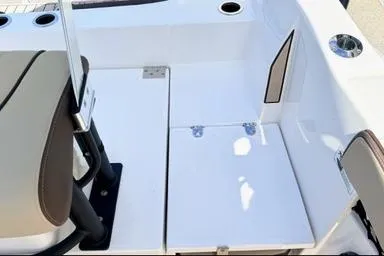 Slide: The Image of 2025 Yamaha Boats 222 FSH Sport E interior seating and storage area. - 10