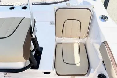Slide: The Image of 2025 Yamaha Boats 222 FSH Sport E interior seating, featuring beige and brown cushioned seats. - 11