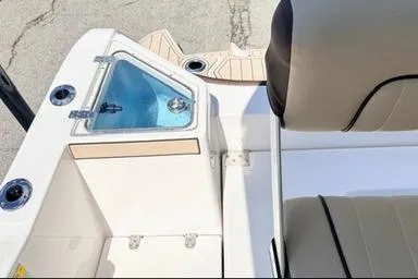 Slide: The Image of 2025 Yamaha Boats 222 FSH Sport E interior with seating and storage features. - 12