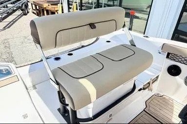 Slide: The Image of 2025 Yamaha Boats 222 FSH Sport E, beige seating, modern design, outdoor setting. - 13