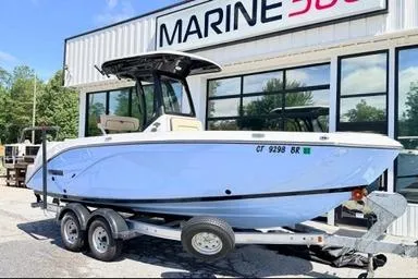Slide: The Image of 2025 Yamaha Boats 222 FSH Sport E on trailer outside Marine dealership. - 2