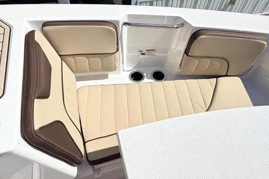 Slide: The Image of 2025 Yamaha Boats 222 FSH Sport E interior seating with beige and brown cushions. - 26