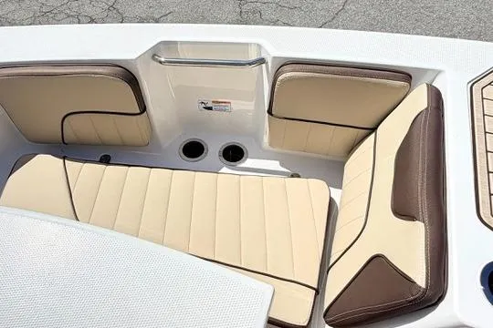 Slide: The Image of 2025 Yamaha Boats 222 FSH Sport E interior seating with beige and brown upholstery. - 27