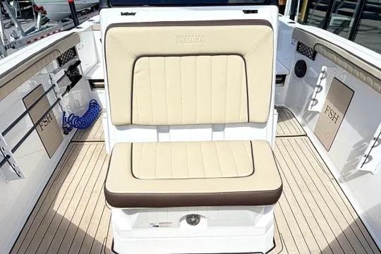Slide: The Image of 2025 Yamaha Boats 222 FSH Sport E interior with beige seating and deck. - 29