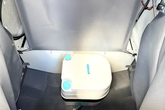 Slide: The Image of Portable toilet inside 2025 Yamaha Boats 222 FSH Sport E, showcasing compact marine convenience. - 31