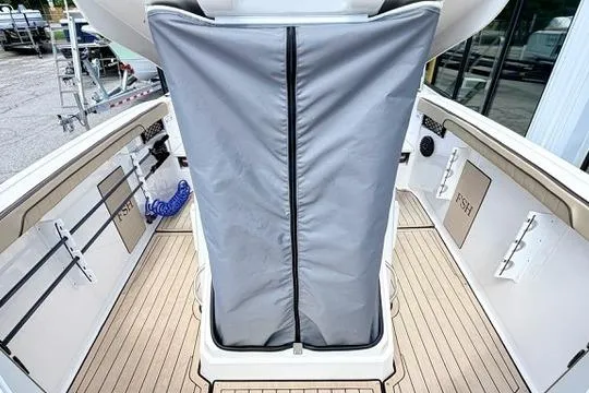 Slide: The Image of 2025 Yamaha Boats 222 FSH Sport E interior with covered console and teak flooring. - 32