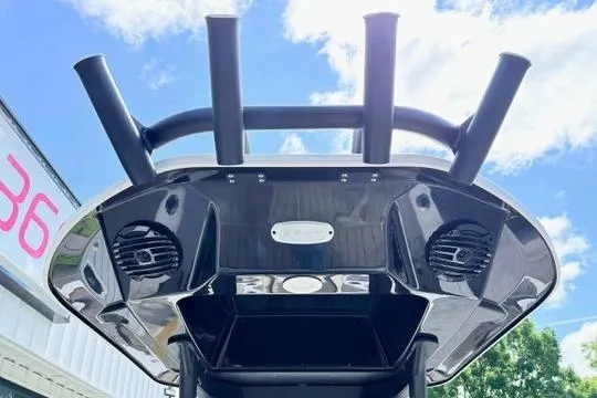 Slide: The Image of 2025 Yamaha Boats 222 FSH Sport E, sleek design with rod holders and speakers under a clear sky. - 33