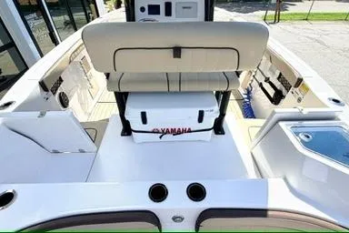 Slide: The Image of 2025 Yamaha Boats 222 FSH Sport E interior with seating and storage compartments. - 9