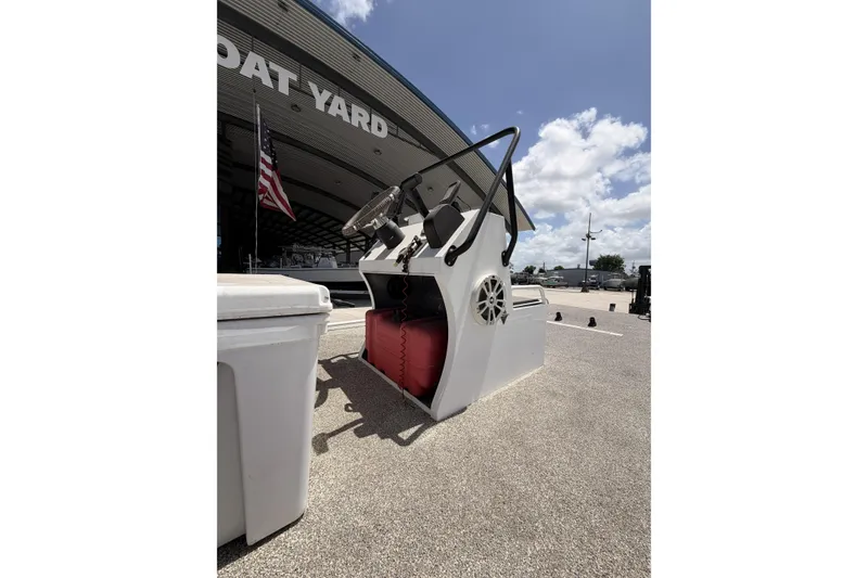 Slide: The Image of Custom 2017 Battersea boat console at a boat yard under a clear sky. - 12