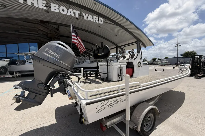 Slide: The Image of Custom 2017 Battersea boat with Yamaha motor at The Boat Yard under a sunny sky. - 2