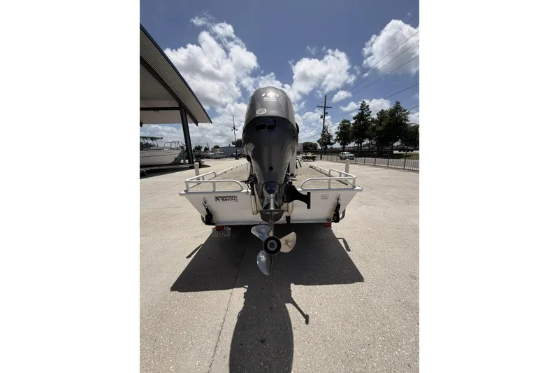 Slide: The Image of Rear view of a 2017 Custom Battersea boat with outboard motor in a sunny marina. - 3
