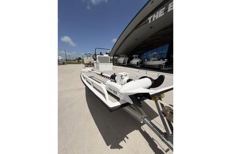 Slide: The Image of Custom 2017 Battersea boat on trailer, parked outside a showroom under a clear blue sky. - 9