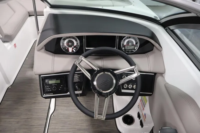 Slide: The Image of 2026 Four Winns HD3 boat dashboard with steering wheel and gauges. - 1