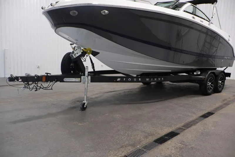 Slide: The Image of 2026 Four Winns HD3 boat on trailer in indoor setting. - 11