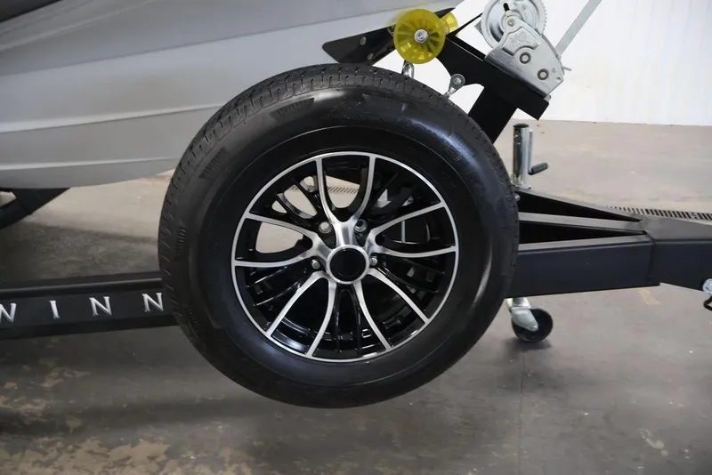 Slide: The Image of Trailer wheel of 2026 Four Winns HD3 boat, featuring sleek black and silver alloy design. - 15
