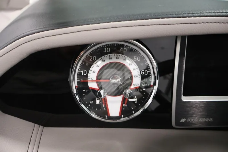 Slide: The Image of Dashboard of 2026 Four Winns HD3 boat with speedometer and fuel gauge. - 2