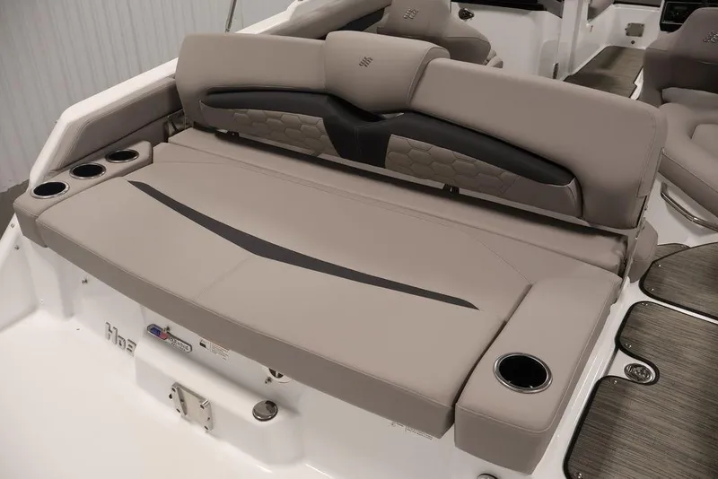Slide: The Image of 2026 Four Winns HD3 boat interior with beige seating and cup holders. - 20