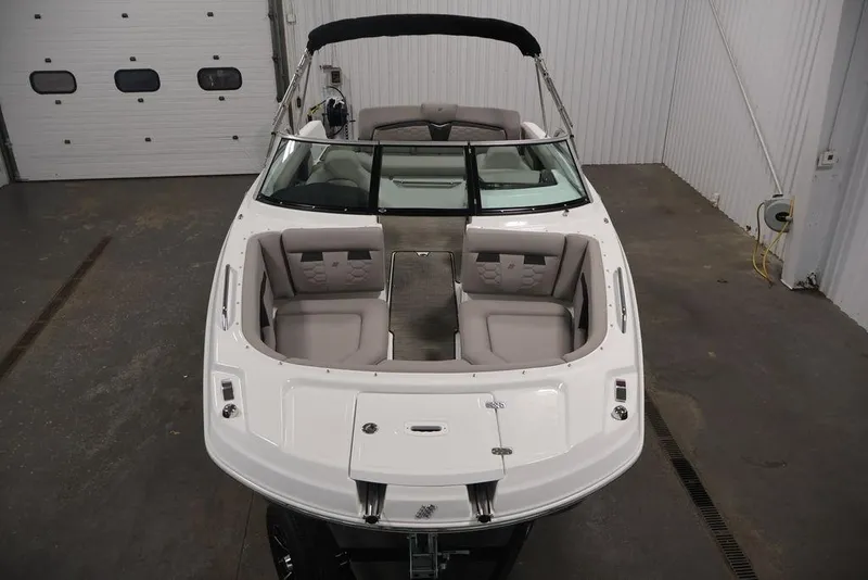 Slide: The Image of 2026 Four Winns HD3 boat with spacious seating in a garage setting. - 22