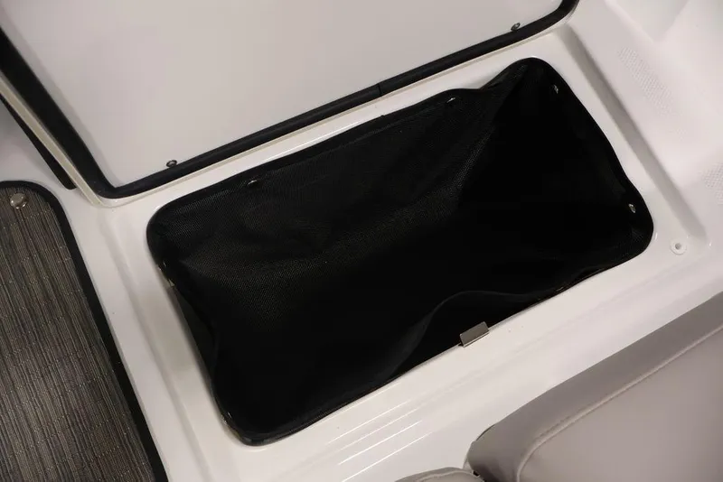 Slide: The Image of Storage compartment in 2026 Four Winns HD3 boat, featuring a black mesh liner. - 24