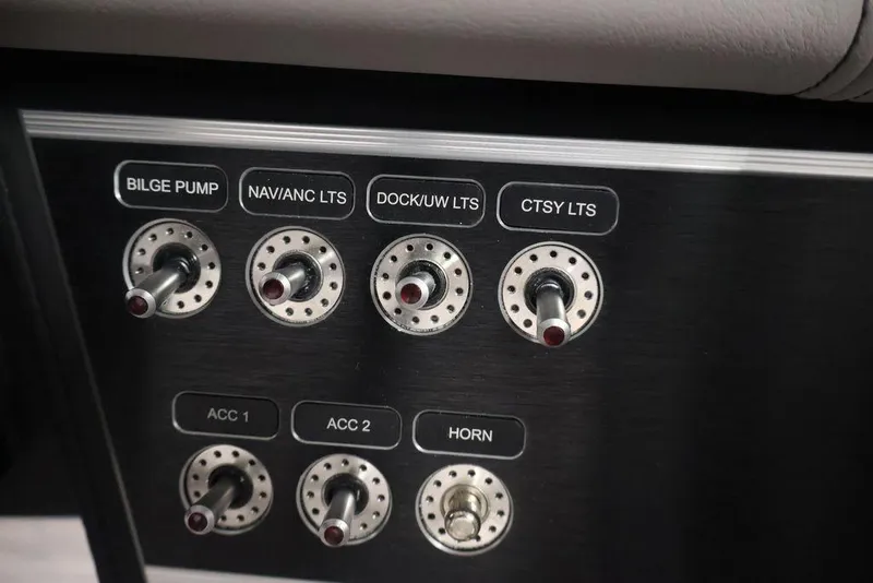 Slide: The Image of Control panel of 2026 Four Winns HD3 boat with labeled switches for various functions. - 33