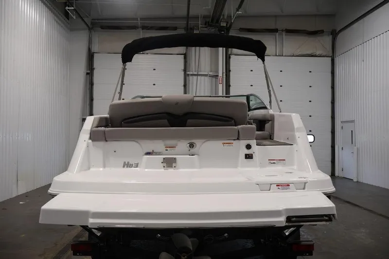 Slide: The Image of 2026 Four Winns HD3 boat rear view in a garage setting. - 35