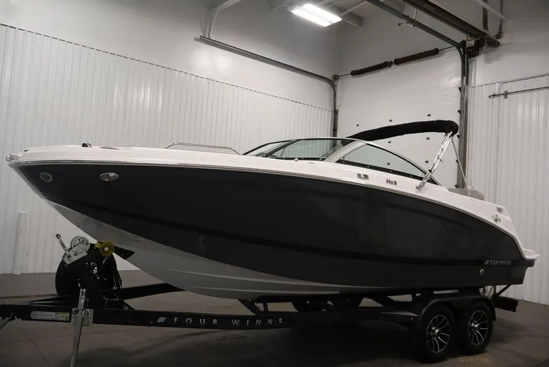 Slide: The Image of 2026 Four Winns HD3 boat on trailer in indoor storage facility. - 37