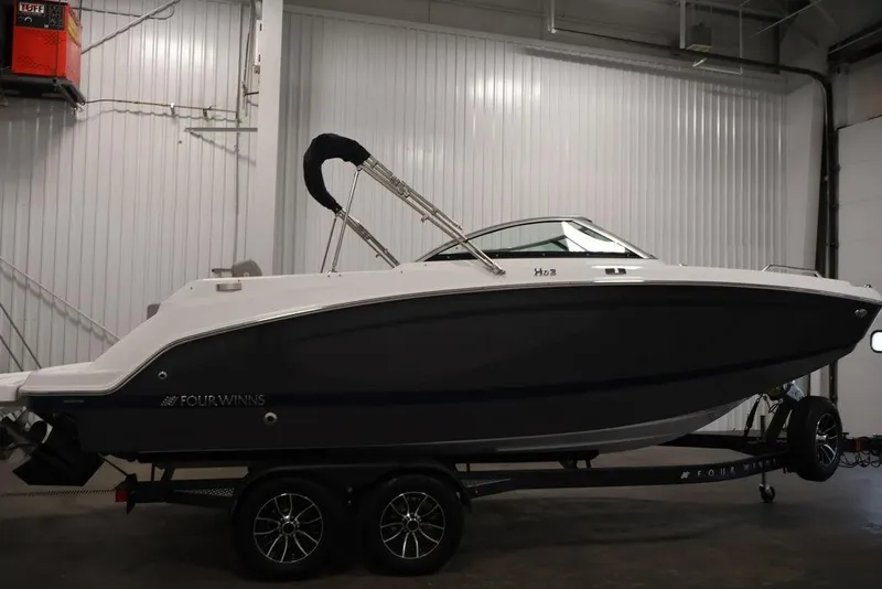 Slide: The Image of 2026 Four Winns HD3 boat on trailer in indoor storage facility. - 46