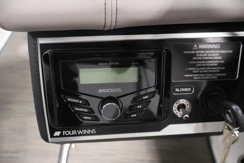 Slide: The Image of 2026 Four Winns HD3 boat media center with Kicker audio system and safety warning label. - 48