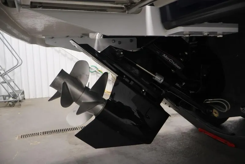Slide: The Image of 2026 Four Winns HD3 boat with MerCruiser outdrive and dual propellers in a garage setting. - 5