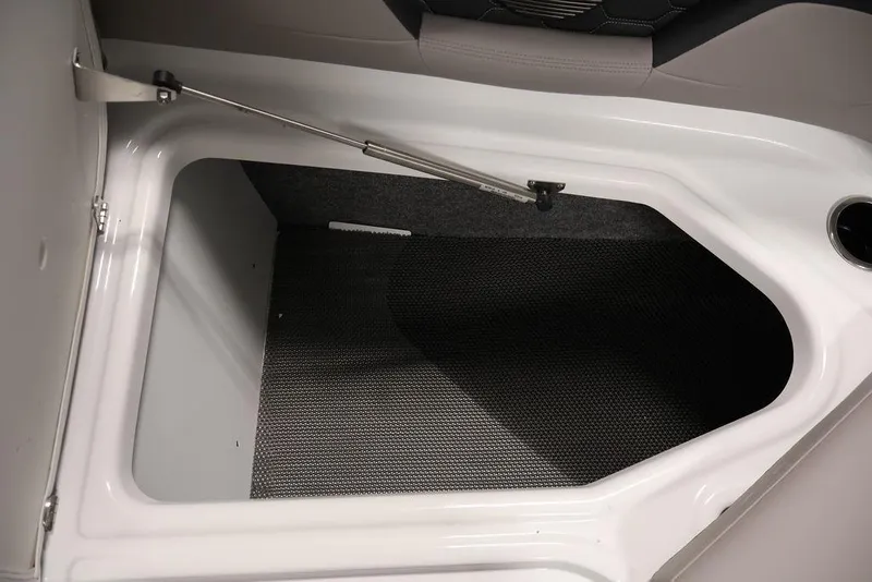 Slide: The Image of 2026 Four Winns HD3 boat storage compartment with open lid and carpeted interior. - 51