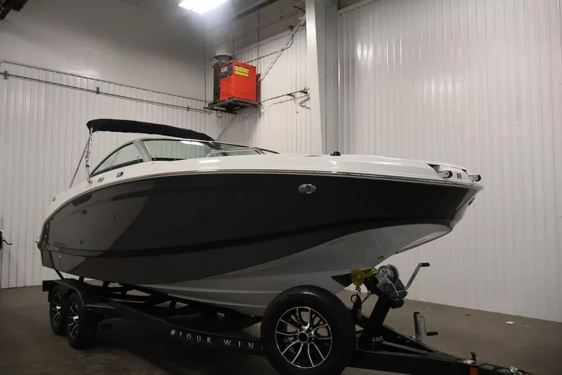 Slide: The Image of 2026 Four Winns HD3 boat on trailer in indoor storage facility. - 52