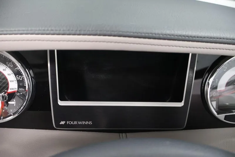Slide: The Image of Dashboard of 2026 Four Winns HD3 boat with speedometer and display panel. - 8
