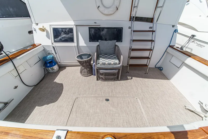 Slide: The Image of 1991 Californian 55 Cockpit Motor Yacht interior with seating, ladder, and nautical decor. - 10