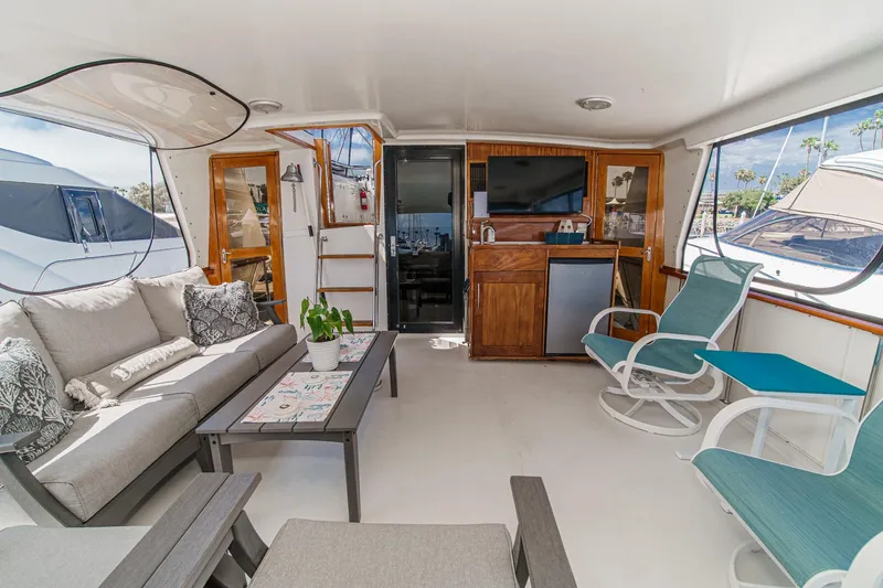 Slide: The Image of Luxurious 1991 Californian 55 Cockpit Motor Yacht interior with cozy seating and modern amenities. - 13