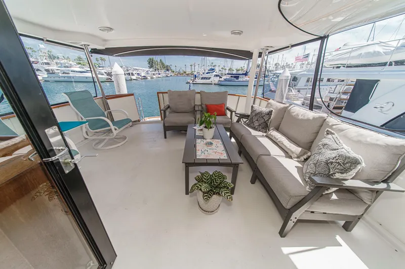 Slide: The Image of Luxurious 1991 Californian 55 Cockpit Motor Yacht with spacious outdoor seating area. - 14