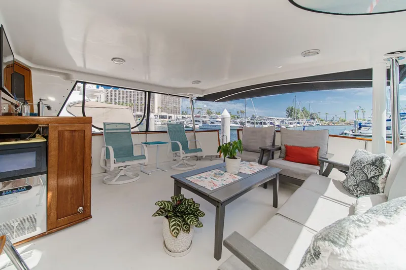 Slide: The Image of Spacious cockpit of 1991 Californian 55 Motor Yacht with comfortable seating and marina view. - 15