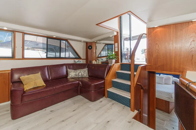 Slide: The Image of Luxurious interior of 1991 Californian 55 Cockpit Motor Yacht with leather seating and wooden accents. - 20