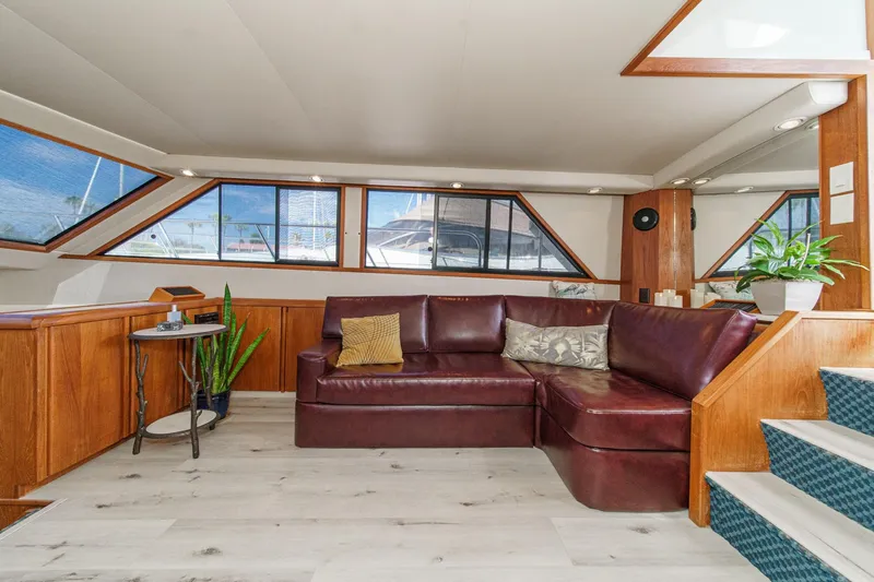Slide: The Image of Luxurious interior of 1991 Californian 55 Cockpit Motor Yacht with leather seating and wooden accents. - 21