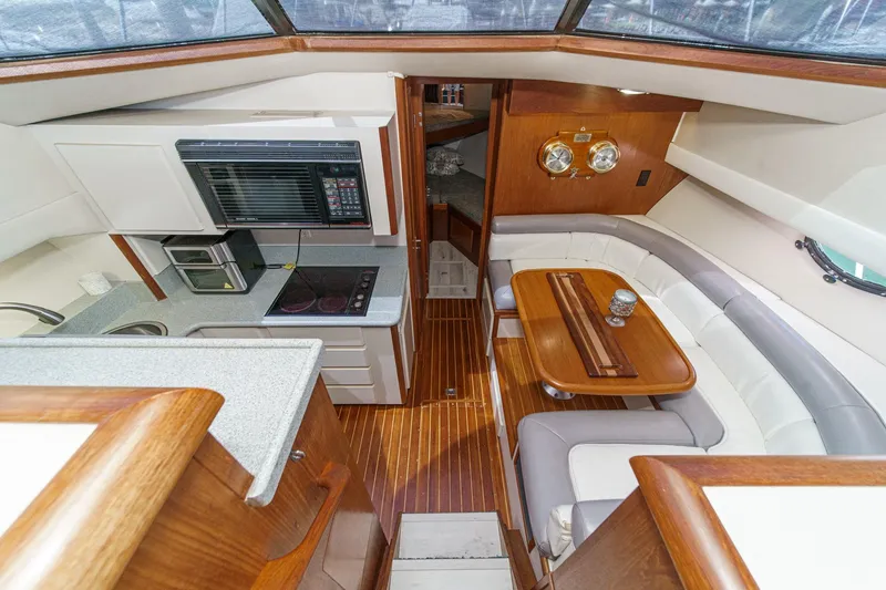 Slide: The Image of Interior of 1991 Californian 55 Cockpit Motor Yacht with kitchen and dining area. - 25
