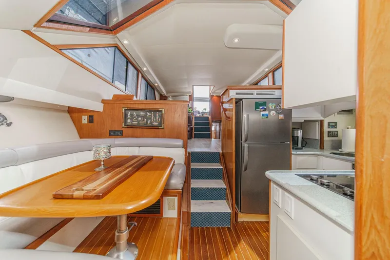 Slide: The Image of Interior of 1991 Californian 55 Cockpit Motor Yacht with dining area and kitchen. - 26