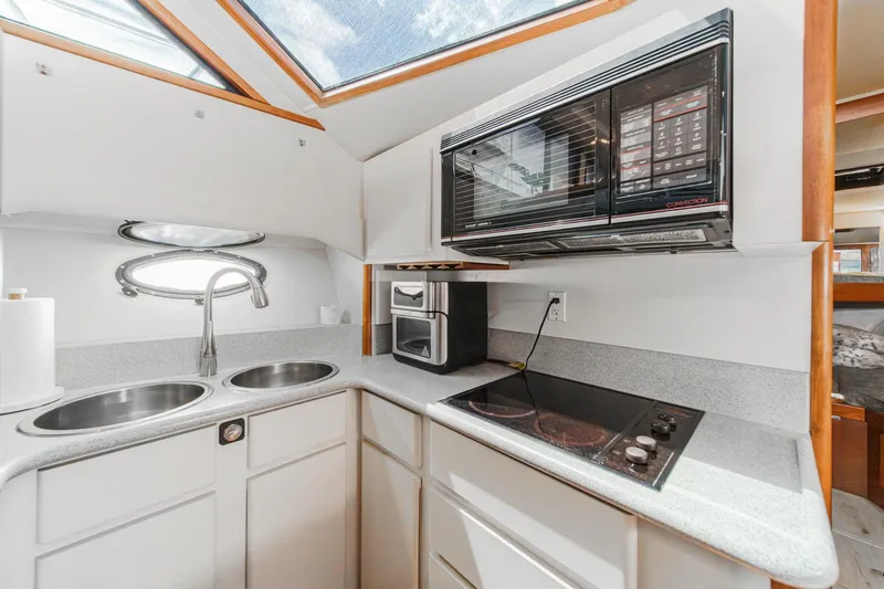 Slide: The Image of Modern kitchen in 1991 Californian 55 Cockpit Motor Yacht with dual sinks and appliances. - 29