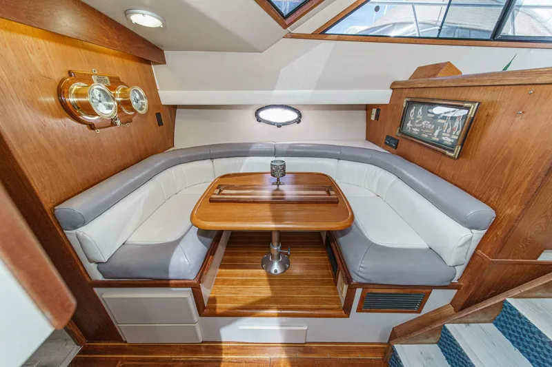 Slide: The Image of Luxurious 1991 Californian 55 Cockpit Motor Yacht interior with elegant dining area. - 30