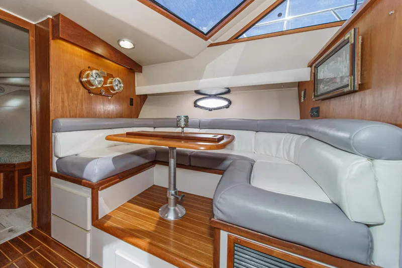 Slide: The Image of Luxurious 1991 Californian 55 Cockpit Motor Yacht interior with elegant seating and wooden accents. - 31